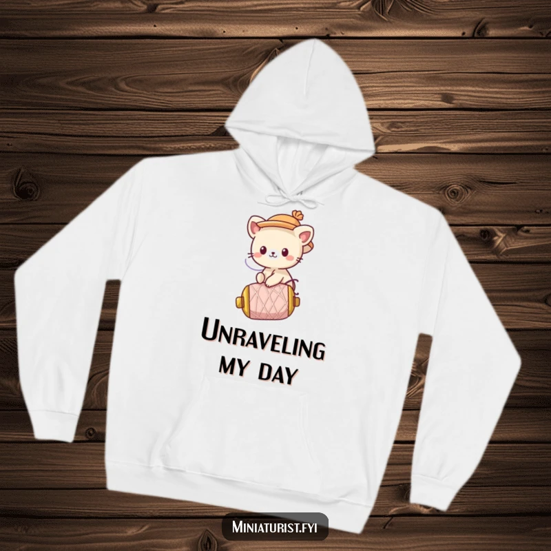 Funny Hoodie: A cute animal character with a tiny hat rides a runaway spool of thread, full of excitement.