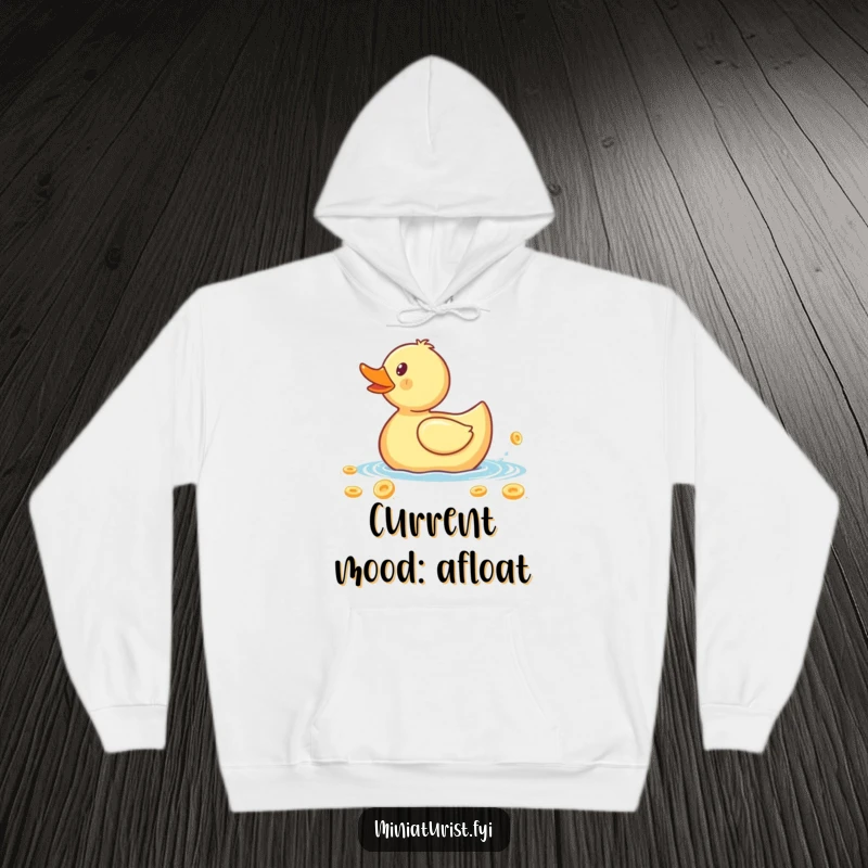 Funny hoodie design featuring a tiny rubber ducky paddling a massive cereal flake, embodying a spirited and humorous morning quest.
