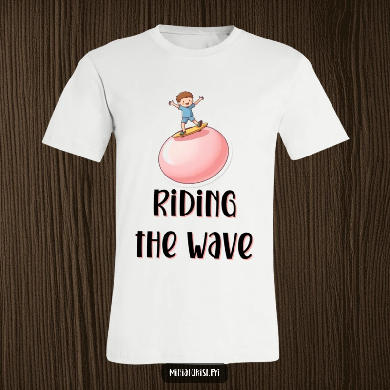 Funny miniature person enthusiastically surfing on a ridiculously large, upturned button, featured on this comfortable graphic tee.